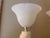 and elegant flared frosted glass shades. The distinctive asymmetrical bases feature sweeping, tiered ridges that create a...