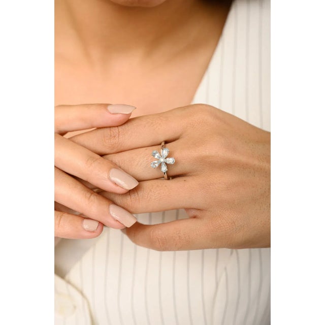 Natural Aquamarine Diamond Spring Flower Ring in 18K Gold featuring natural aquamarine of 0.86 carats and diamonds of 0.04...
