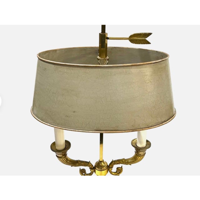 A divine pair of vintage gilt brass bouillotte lamps that bring timeless elegance to any interior. These classic French-...