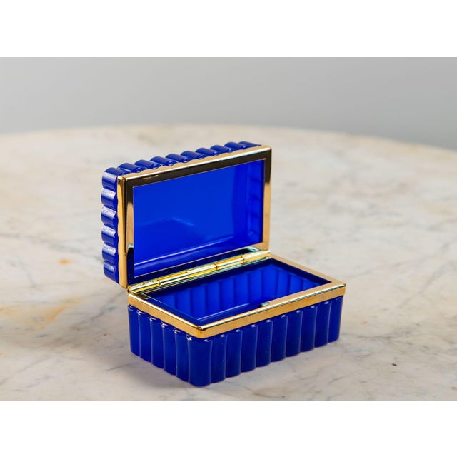 An antique French opaline glass casket box in a striking lapis lazuli color. The polished glass is mounted with gold...