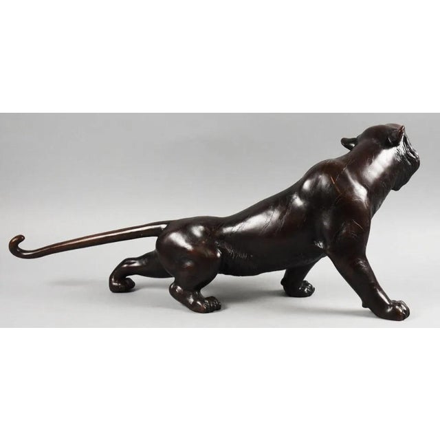 This Tiger appears cast bronze with no visible maker's marks. Measures approx. 29" x 12" tall. This piece was in a...