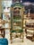 This magnificent French Louis XVI style vitrine features an elegant green finish beautifully accented with lavish gold...