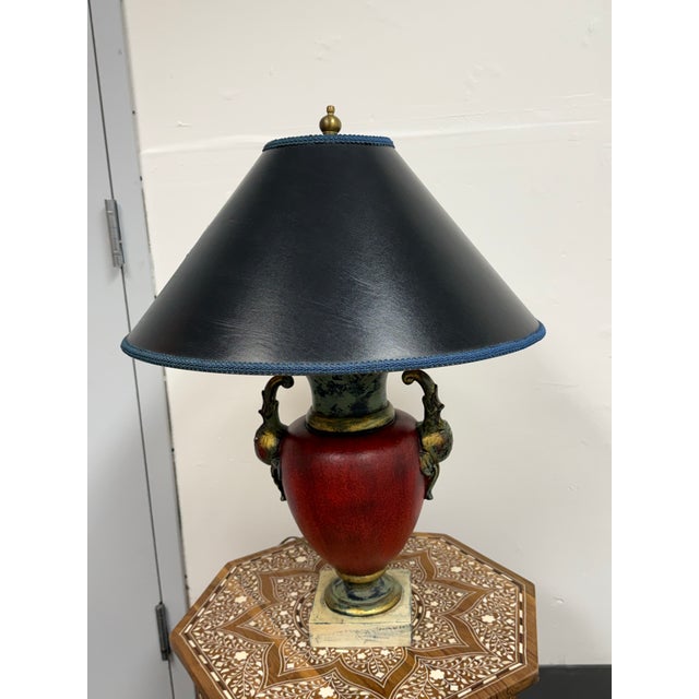 Design Plus Gallery presents a Neoclassical Gilt Patina Red Urn Table Lamp, Figural Handles. This table lamp has a...