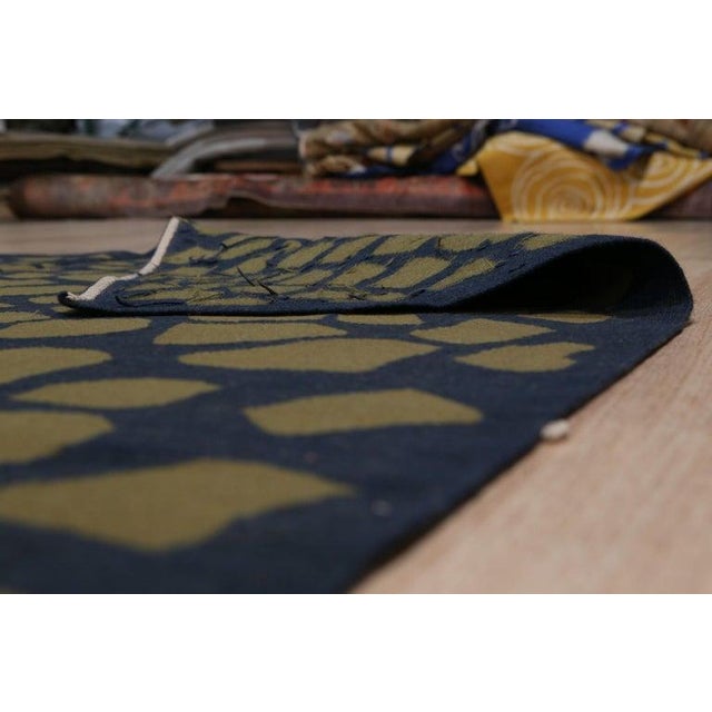 This green wool rug features a durable flat weave construction suitable for a variety of residential environments. Crafted...