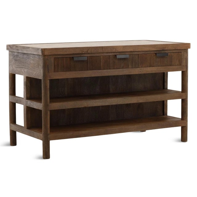 Richly grained walnut brown finish mango wood kitchen island with hand-fitted tendu marble inset top. The softly framed...