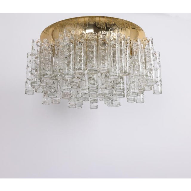 Fantastic chrome mid-century chandelier by doria, germany, manufactured circa 1960-1969. Several murano glass cylinders...
