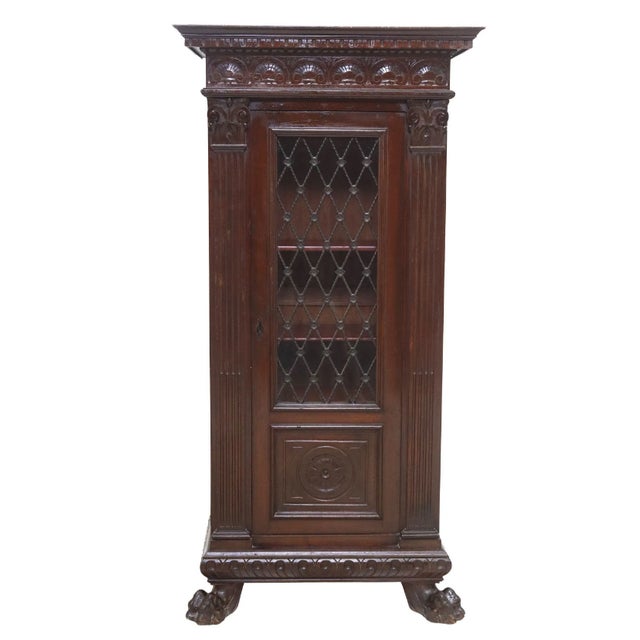 Italian Renaissance Revival walnut bookcase, early 20th century, having molded cornice, over carved shell motifs and...