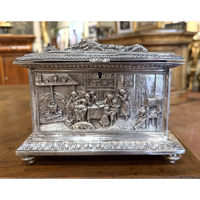 This richly decorated antique jewelry casket combines elaborate relief work with an unusually theatrical series of...