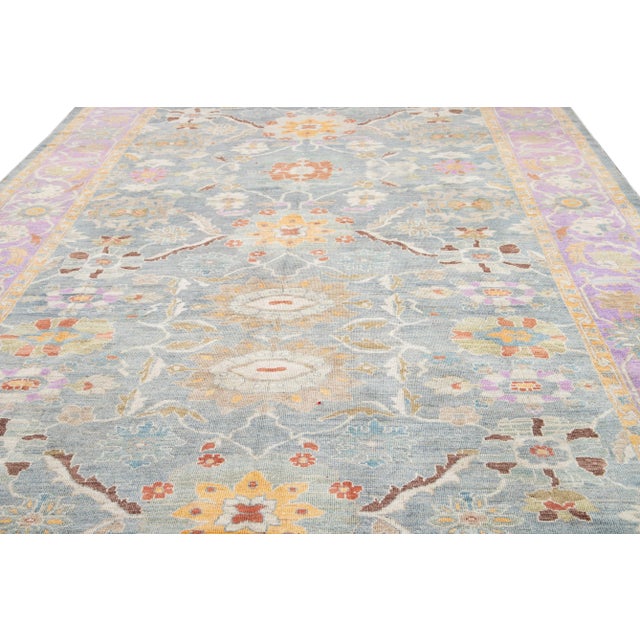 Beautiful contemporary Sultanabad rug hand-knotted wool rug with a blue field. This Persian rug has a purple frame and...
