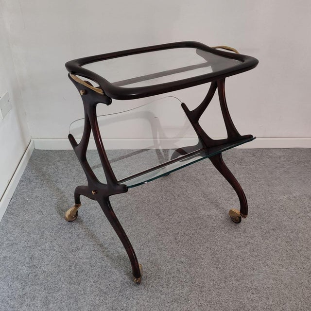 Mid-Century Modern Italian Wood and Brass Bar Cart with Magazine Rack, Attributed to Cesare Lacca, 1950s An elegant and...
