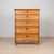 A charming early 20th-century pine tallboy chest of drawers, likely of Central or Northern European origin, possibly...
