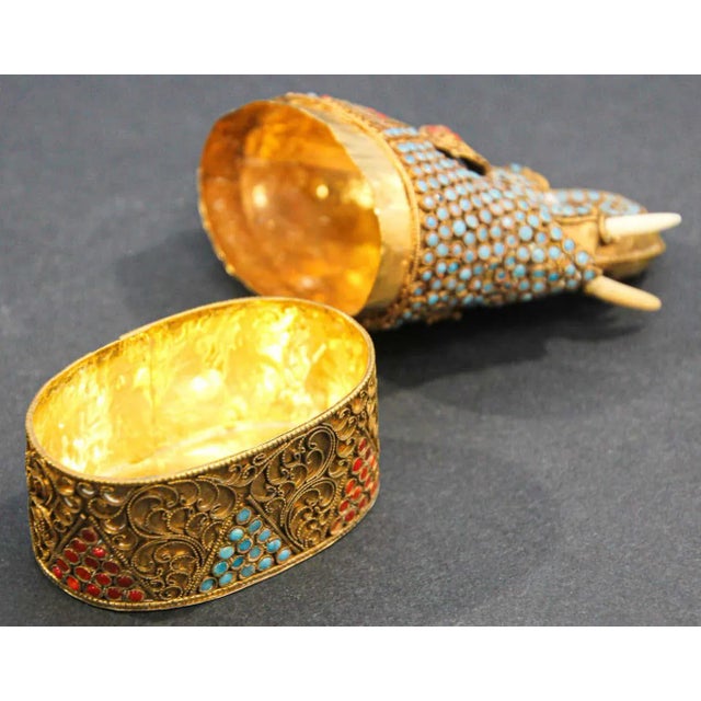 Vintage gilt brass lidded trinket snuff box with red and turquoise stone inlaid in the form of an elephant with trump up....
