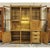 This asymmetrical cabinet features three glass-front display sections above a lighted open center, creating a balanced mix...