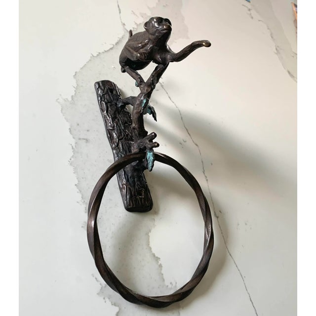 Delightful and well made dark brown iron monkey perched in a tree. Has 2 hole metal base for surface attachment .
