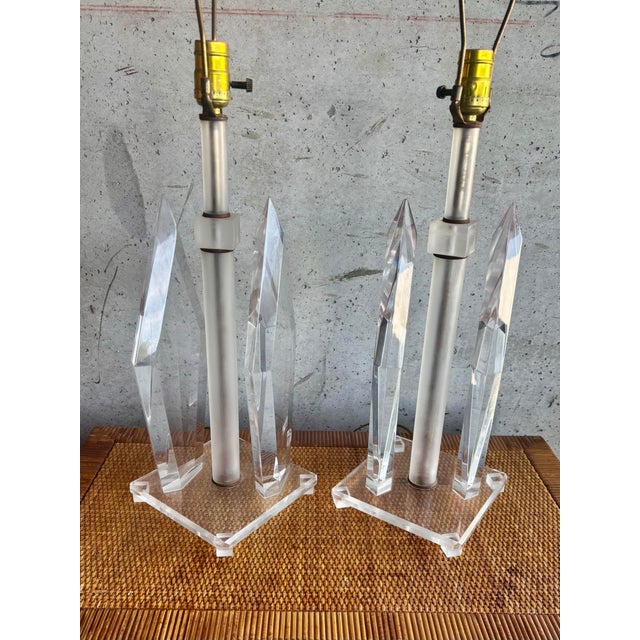 A refined pair of vintage lucite table lamps from the 1970s, showcasing classic mid century modern symmetry and sculptural...