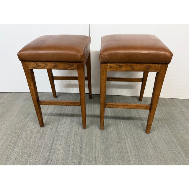 Design Plus Gallery presents a Pair of Counter Stools from Brownstone Furniture. The stools have a harmonious tone of...