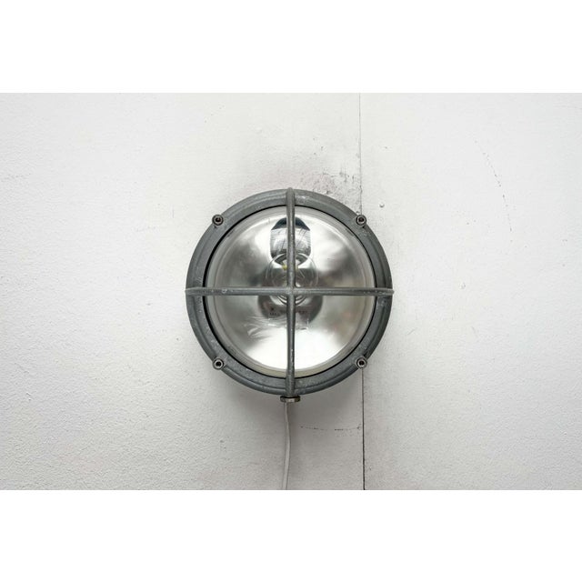 Robust outdoor wall lamp by the Danish manufacturer Louis Poulsen, based on a design by Lauritz Knudsen from the early...