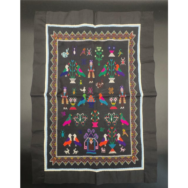 This beautiful Hmong embroidered story cloth, also known as Paj Ntaub, features various animals and human figures and a...