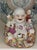 This vintage Chinoiserie style porcelain figure of Budai, the Laughing Buddha is seated and surrounded by five playful...