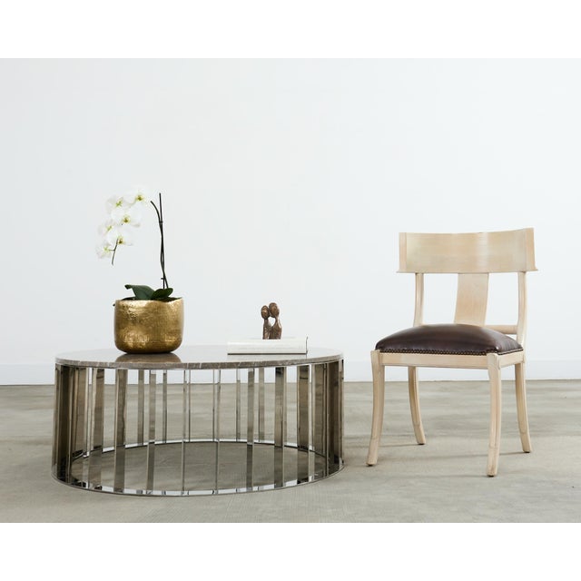 Stylish and unique modern marble top cocktail or coffee table featuring a fan blade style base. The base is constructed...