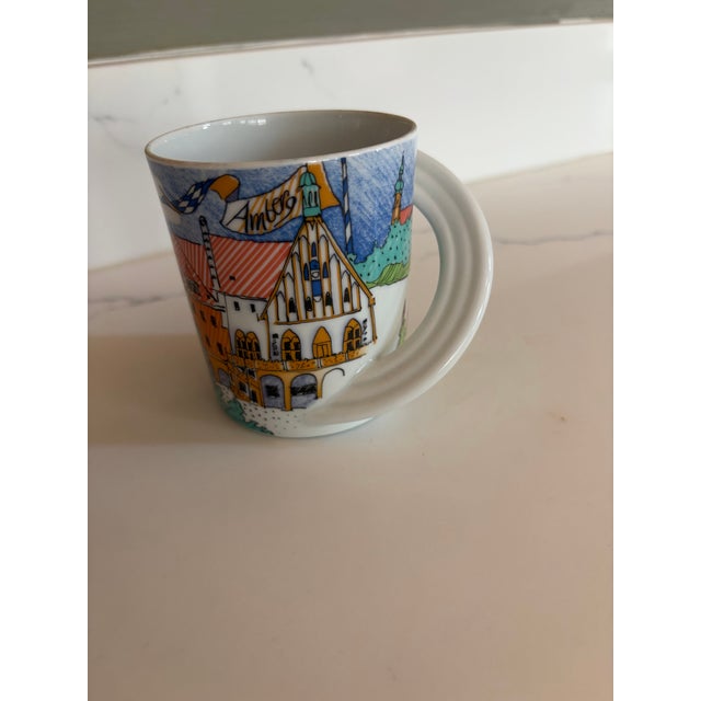 striking porcelain mug is part of the Rosenthal Studio-Linie (Studio Line) series, featuring the "Amberg" city motif....