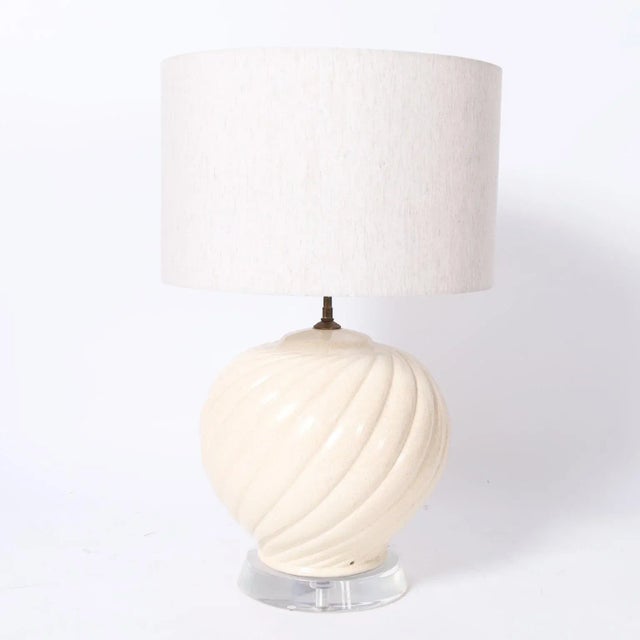 Chic Mid-Century Karl Springer style Italian table lamp with a swirling ceramic body over a lucite base.