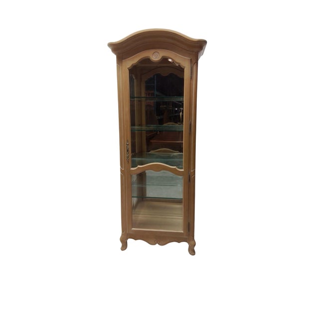 Elegant and timeless, this Ethan Allen French Country curio cabinet features a classic bisque-finished wood frame with...