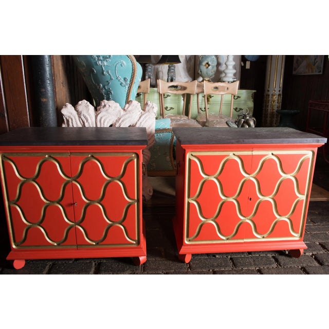 A pair of reddish-orange with gold trim Espana chests designed for Henredon by the premiere decorator, Dorothy Draper in...
