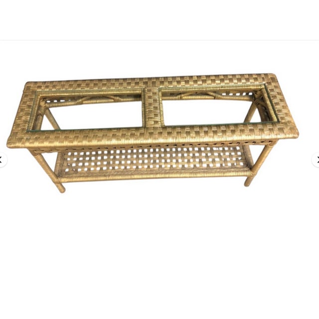 This vintage rattan two tier console table is a charming piece of furniture that exudes a sense of nostalgia. Standing at...