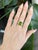 5.8 carat oval peridot set in solid 14K gold, radiating vibrant lime-green brilliance. Accented with natural diamonds,...