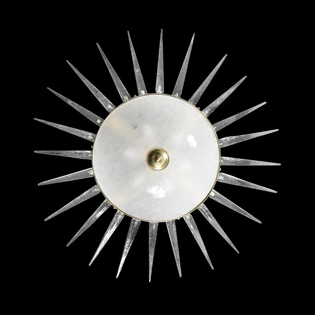 This striking modernist chandelier is a testament to the exquisite craftsmanship of 20th-century Murano glassmaking....