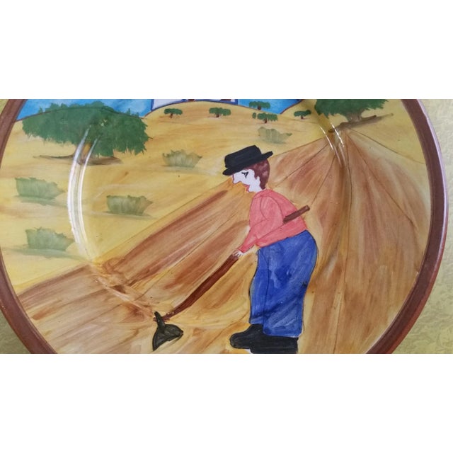 Here's a great piece of folk art from Portugal. It features a farmer working in his field. Colors are bright and the...