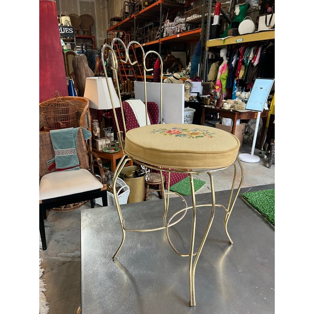 Up for consideration is a beautiful vintage metal vanity chair with a needlepoint cushion. This would look lovely in use...