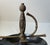 A Spanish made unusual ashtray in sculpted brass and black/dark grey lacquered metal. Its center sword handle that holds...