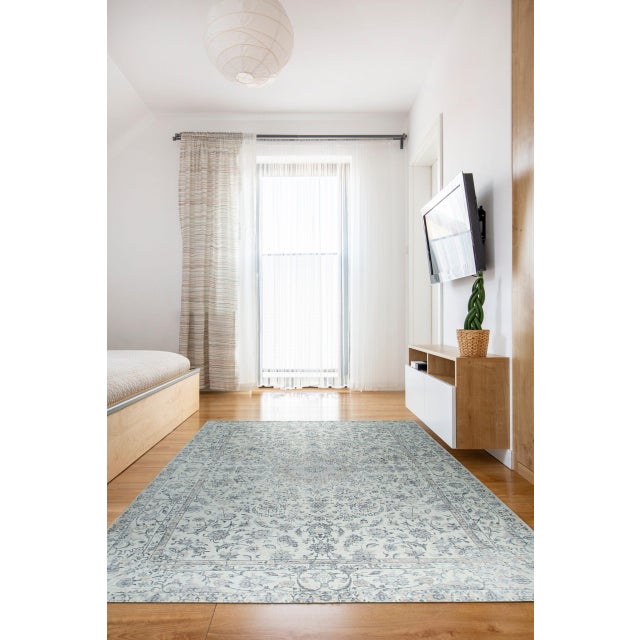 Sleek Rustic Beige Handmade Wool Rug, Country of Origin: India. This exquisite hand-knotted piece embodies the refined...