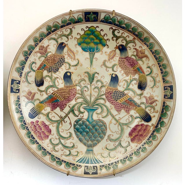 A stunning pair of vintage chinoiserie decorative plates featuring hand-painted birds, florals, and botanical motifs....