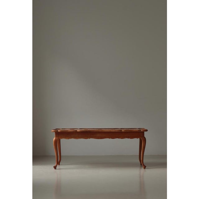 An elegant coffee table attributed to Frits Henningsen, Denmark, exemplifying the refined craftsmanship and understated...