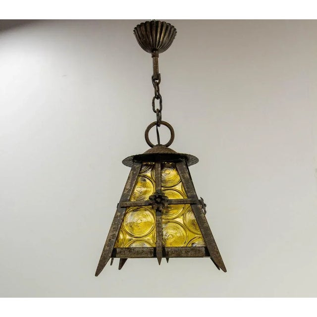 Mid century period chandelier or lustre, french wrought iron, colored yellow and textured glass made in the 20th mid...