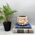 Charming, vintage Hawaiian cachepot crafted from brown-glazed terracotta and densely embellished with an assortment of...