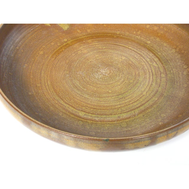 Turned pottery bowl with a lively drip and spatter glaze in earth tones. No maker's mark. Please read condition statement.