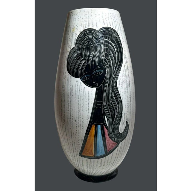 Elegant glazed ceramic vase, likely of Italian or French origin, dating to the 1960s. The elongated oval body () features...