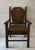 Vintage wood child's chair in an Arts and Crafts or Mission style design featuring a dark stain, geometric backrest panel...