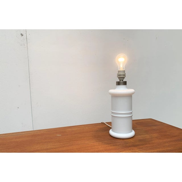 Rare table lamp from the Danish manufacturer Holmegaard after a design by Sidse Werner from the early 80s. The matching...