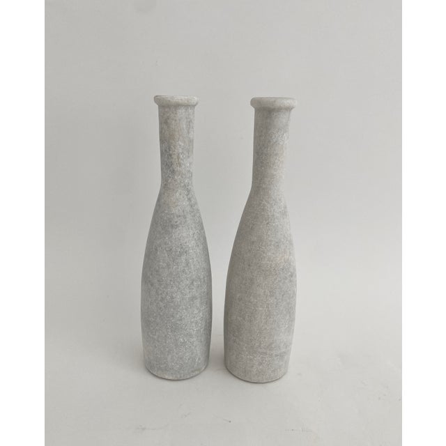 Solid hand-hewn white marble candleholders with gray veins reminiscent of bowling pins. Clean lines and one of a kind...