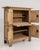 A bold Brutalist cabinet crafted in solid oak, showcasing strong geometric forms and textured surfaces characteristic of...