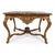 This is a 20th century French Louis XV style heavily carved fruitwood and gilt marble top table by Maitland -Smith. The...