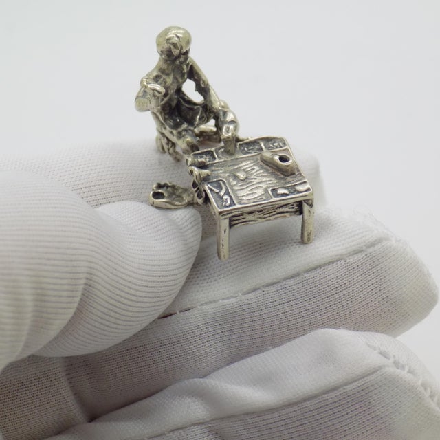 A charming and narrative driven miniature, this vintage Italian piece portrays a shoemaker at work, captured in solid...