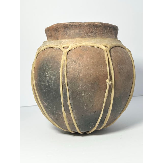 Vintage Tarahumara Clay Handmade Pottery Vase Animal Hide Sinew 7 1/2” Good vintage condition. No cracks or damage to...