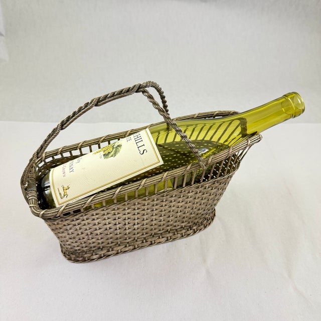 From France, a complex woven silver tone metal wine bottle caddy, circa 1930s. Beautifully made with a technique that uses...
