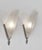 Donna Paris A pair of 1925-1935 French art deco wall sconces in nickel on cast solid brass holding slip shades in clear...